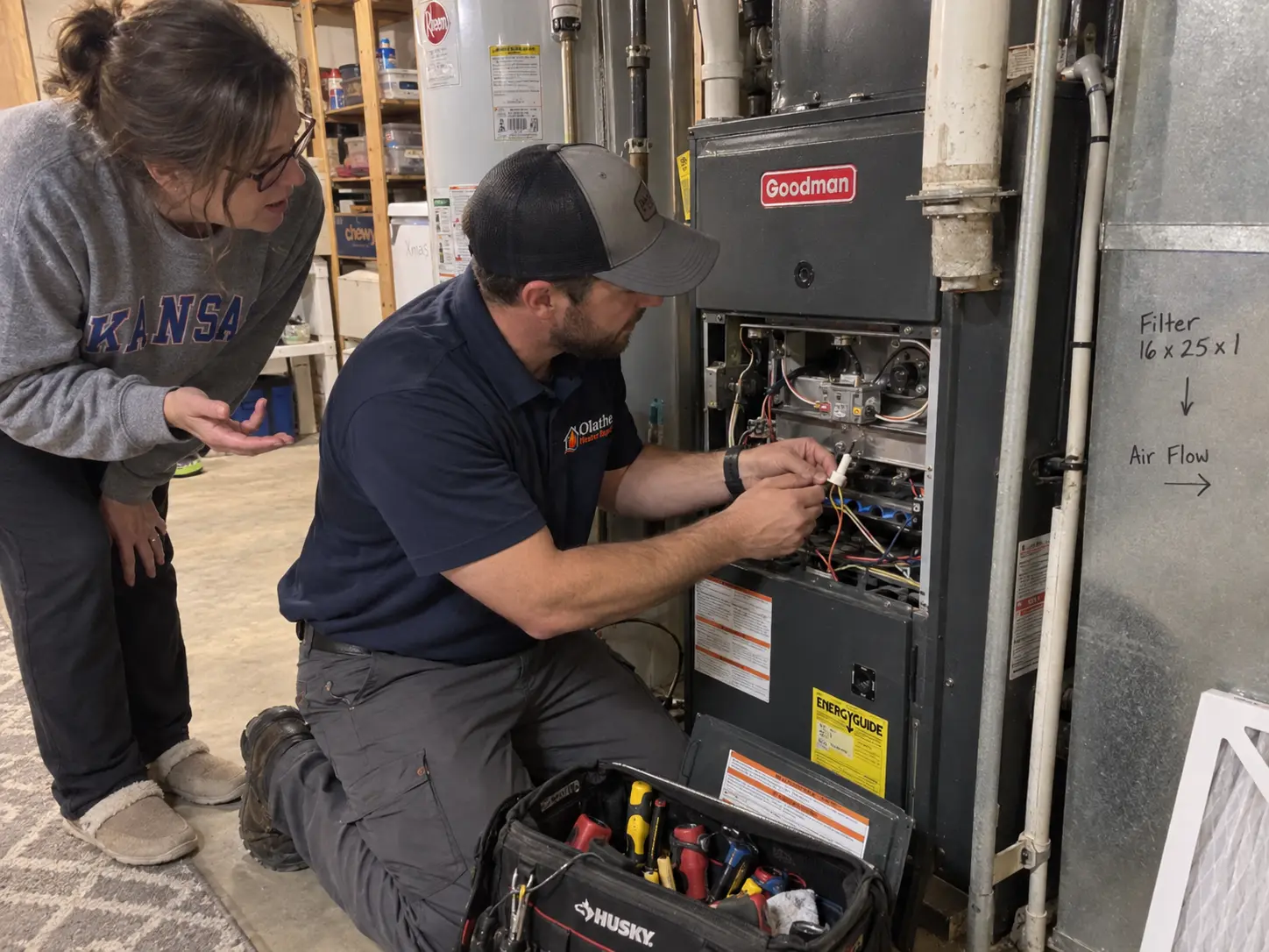 Technician servicing the burner compartment of a Goodman furnace in a residential basement